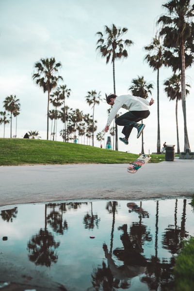 The man in the street skateboarding
